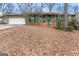 Charming brick home with green shutters, a well-manicured yard, and a two-car garage at 693 Trailwood Dr, Riverdale, GA 30274
