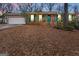 Charming brick home featuring green door, shutters and a white garage door at 693 Trailwood Dr, Riverdale, GA 30274