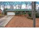 Charming brick home featuring green door, shutters and a white garage door at 693 Trailwood Dr, Riverdale, GA 30274