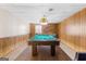 A game room features wood paneling, a drop ceiling, and a pool table at 693 Trailwood Dr, Riverdale, GA 30274