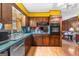 An efficient kitchen features wood cabinets, a stainless steel dishwasher, and laminate countertops at 693 Trailwood Dr, Riverdale, GA 30274