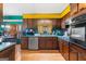 Vintage kitchen with wood cabinets, laminate countertops, stainless steel dishwasher, and eat-in dining at 693 Trailwood Dr, Riverdale, GA 30274
