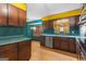 Vintage kitchen with wood cabinets, laminate countertops and stainless steel dishwasher at 693 Trailwood Dr, Riverdale, GA 30274