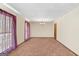 Open-concept living room with carpeting and a bright window to enjoy natural light at 693 Trailwood Dr, Riverdale, GA 30274