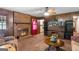 Cozy Gathering room features a brick fireplace, wood paneling, and comfortable seating at 693 Trailwood Dr, Riverdale, GA 30274