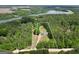 Aerial view showcases the property's location near a lake and surrounded by lush trees at 138 Sam Solomon Rd, Locust Grove, GA 30248