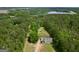 Stunning aerial view of home surrounded by trees, situated near a lake at 138 Sam Solomon Rd, Locust Grove, GA 30248
