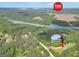 Aerial view of house and location pin shown near lake and outlet mall at 138 Sam Solomon Rd, Locust Grove, GA 30248