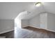 Open attic area with sloping ceilings, a skylight and hardwood floors at 138 Sam Solomon Rd, Locust Grove, GA 30248
