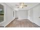 Bright bedroom features a ceiling fan, wood-look flooring, neutral paint, and natural light at 138 Sam Solomon Rd, Locust Grove, GA 30248