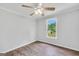 Cozy bedroom features hardwood floors, neutral paint, a ceiling fan, and a bright window view at 138 Sam Solomon Rd, Locust Grove, GA 30248