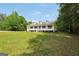 Traditional white home with a welcoming porch and expansive front lawn at 138 Sam Solomon Rd, Locust Grove, GA 30248