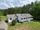 Charming home with a welcoming front porch, lush lawn, and well-maintained landscaping at 138 Sam Solomon Rd, Locust Grove, GA 30248