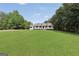 Charming white house featuring a well-manicured lawn and inviting front porch at 138 Sam Solomon Rd, Locust Grove, GA 30248