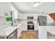 Updated kitchen showcasing stainless steel appliances, white cabinets, and a large island with a white countertop at 138 Sam Solomon Rd, Locust Grove, GA 30248