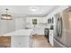 Bright kitchen featuring white cabinets, stainless steel appliances, and an island with a white countertop at 138 Sam Solomon Rd, Locust Grove, GA 30248