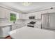 Modern kitchen with stainless steel appliances, white cabinetry, and a bright and airy feel at 138 Sam Solomon Rd, Locust Grove, GA 30248