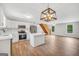Open concept featuring a kitchen and living room, wood flooring, and a staircase at 138 Sam Solomon Rd, Locust Grove, GA 30248