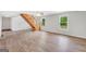 Bright living room featuring beautiful floors and a natural wood staircase at 138 Sam Solomon Rd, Locust Grove, GA 30248