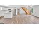 Open-concept living space featuring wood floors, staircase, and a modern kitchen at 138 Sam Solomon Rd, Locust Grove, GA 30248