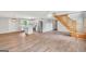 Open-concept living space featuring wood floors, staircase, and a modern kitchen at 138 Sam Solomon Rd, Locust Grove, GA 30248