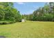 Outbuilding surrounded by grass and trees at 138 Sam Solomon Rd, Locust Grove, GA 30248