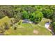 Aerial view of the fenced property with a home, detached garage, gardens, and a long driveway at 614 Highway 85 Conn, Brooks, GA 30205