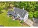Aerial view of home showing the roofline, front yard, two-car garage, and surrounding trees at 614 Highway 85 Conn, Brooks, GA 30205