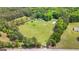 Expansive aerial view of a large property with a home, detached garage, and surrounding trees at 614 Highway 85 Conn, Brooks, GA 30205