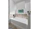 Bright bathroom features a soaking tub with tile surround and black hardware at 614 Highway 85 Conn, Brooks, GA 30205