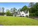 A beautiful two-story home with a large, well-manicured front lawn surrounded by lush trees at 614 Highway 85 Conn, Brooks, GA 30205