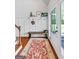 Charming foyer with hardwood floors, board and batten accents, bench, and a stylish rug at 614 Highway 85 Conn, Brooks, GA 30205
