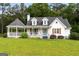 Charming white two-story home with a covered front porch, well-maintained landscaping, and a welcoming blue front door at 614 Highway 85 Conn, Brooks, GA 30205