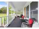 Spacious covered front porch with comfortable seating, ceiling fans, and outdoor views at 614 Highway 85 Conn, Brooks, GA 30205