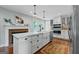 Stylish kitchen boasts a brick fireplace, farmhouse sink, and a large center island at 614 Highway 85 Conn, Brooks, GA 30205