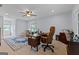 Spacious office featuring two desks, a ceiling fan, and natural light from two windows at 614 Highway 85 Conn, Brooks, GA 30205