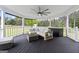 Covered porch with comfortable sectional sofa, ceiling fan, and outdoor wooded views at 614 Highway 85 Conn, Brooks, GA 30205