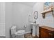Chic powder room with pedestal sink, shiplap wall, and decorative mirror at 614 Highway 85 Conn, Brooks, GA 30205