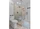 Modern bathroom features a frameless glass shower with tile surround and pebble floor at 614 Highway 85 Conn, Brooks, GA 30205