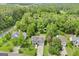 Aerial view of a home surrounded by lush greenery with solar panels on the roof at 103 Manx Dr, Grantville, GA 30220