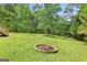 Spacious backyard featuring a fire pit and covered parking, great for outdoor activities at 103 Manx Dr, Grantville, GA 30220