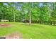 Lush backyard featuring covered parking and a gazebo, perfect for relaxation and storage at 103 Manx Dr, Grantville, GA 30220