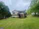 Expansive backyard featuring a large deck and lush green lawn, great for outdoor enjoyment at 103 Manx Dr, Grantville, GA 30220