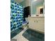 Clean and well-lit bathroom featuring colorful shower curtain and stylish vanity with ample storage at 103 Manx Dr, Grantville, GA 30220