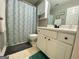 The bathroom features a shower with a patterned curtain, white cabinets, and modern fixtures at 103 Manx Dr, Grantville, GA 30220