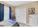 Bedroom featuring window with curtains, closet, and fun decor at 103 Manx Dr, Grantville, GA 30220