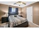 Well-lit bedroom with ceiling fan features a comfortable bed and matching nightstands at 103 Manx Dr, Grantville, GA 30220