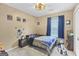 Bedroom features a ceiling fan, window with curtains, and space themed wall art at 103 Manx Dr, Grantville, GA 30220