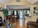 Open-concept dining room featuring hardwood floors, modern chandelier and easy access to kitchen and backyard at 103 Manx Dr, Grantville, GA 30220