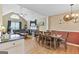 Open floor plan with dining area, fireplace, wood floors, and abundant natural light creates a warm, inviting space at 103 Manx Dr, Grantville, GA 30220